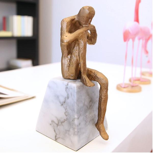 THINKING MAN ON A STONE ORNAMENT