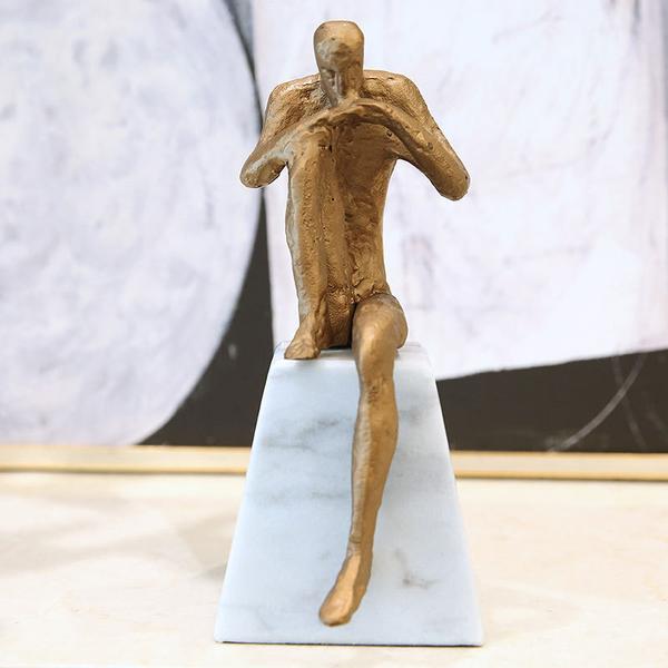 THINKING MAN ON A STONE ORNAMENT