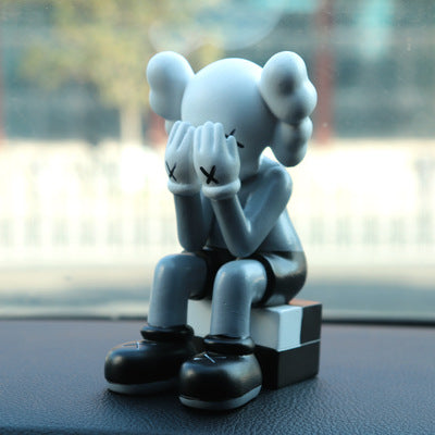BRIAN SITTING KAWS