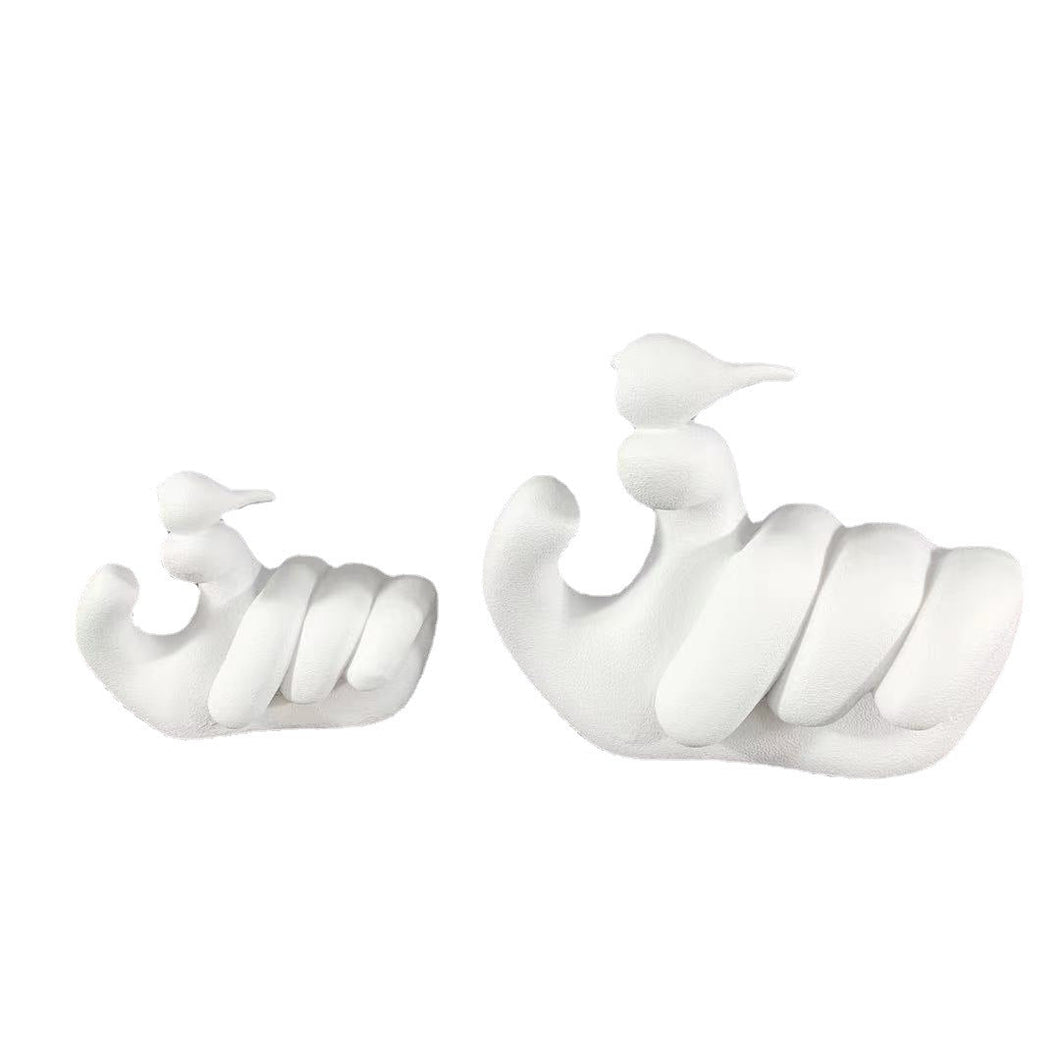 HUMAN HAND HOLDING A BIRD DECORATION